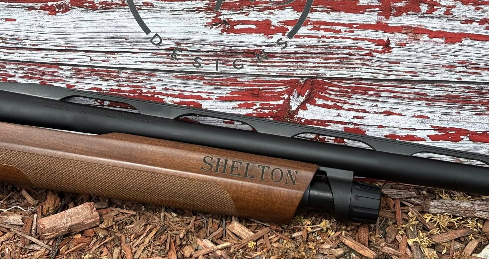 Shelton firearm on a rustic wooden background with 'TOAS Designs' logo.